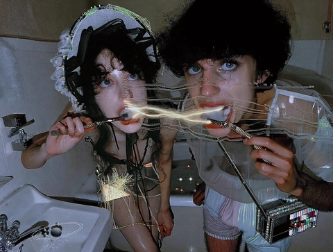 Two people brushing their teeth