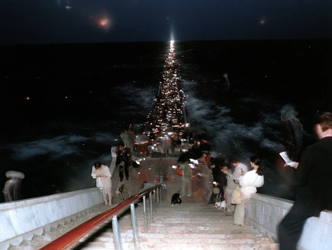 A crowded staircase leading to the sea